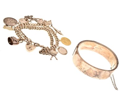 Lot 45 - Silver double-link charm bracelet, attached various charms, and a silver hinged bangle