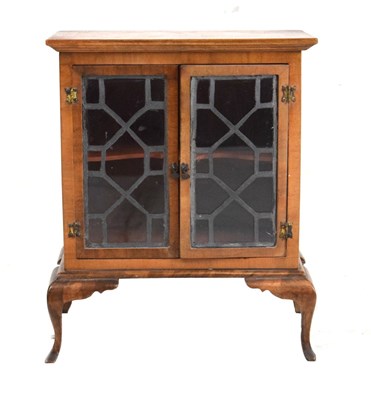 Lot 199 - Miniature walnut two-door cabinet on stand