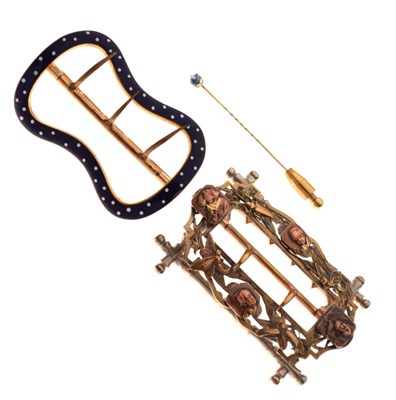 Lot 65 - Two decorative buckles, and an unmarked stick pin set single sapphire cabochon, cased (3)