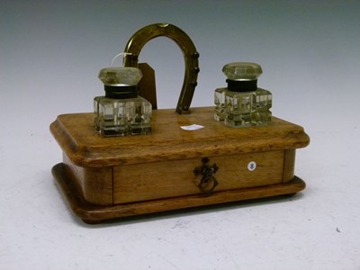 Lot 560 - Late Victorian oak desk stand with brass horseshoe design pen stand