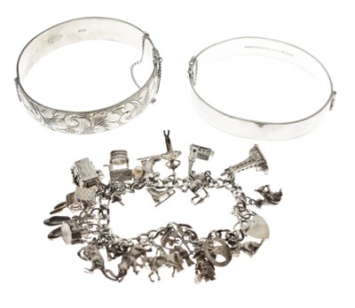 Lot 64 - Two silver snap bangles, and a silver charm bracelet