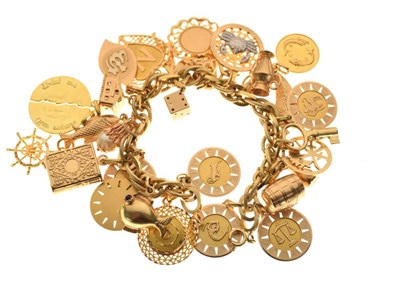 Lot 46 - Yellow metal charm bracelet, stamped 750, 96.2g gross approx