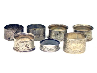 Lot 146 - Three Edward VII silver napkin rings, together with four mixed napkins (7)