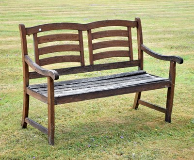 Lot 597 - Teak two-seater garden bench