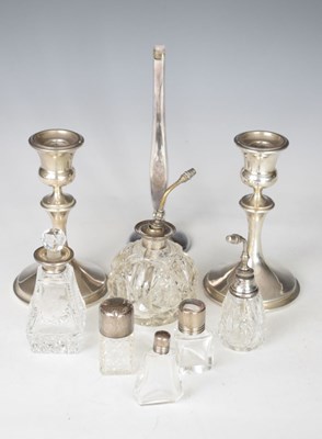 Lot 148 - Quantity of silver to include; bud vase, candlesticks and bottles