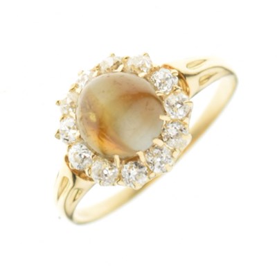 Lot 7 - 'Cats eye' cabochon and diamond cluster ring