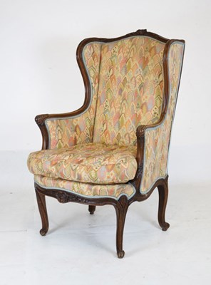 Lot 722 - Late 19th or early 20th Century walnut and upholstered wing armchair