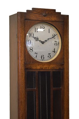 Lot 519 - Art Deco oak- cased chiming longcase clock