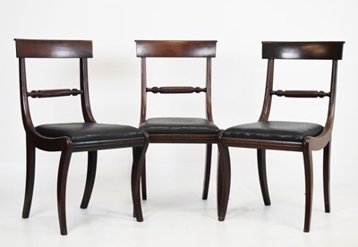 Lot 628 - Set of three sabre leg dining chairs