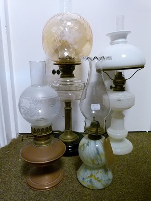 Lot 751 - Group of four late 19th/early 20th century cast metal and glass oil lamps