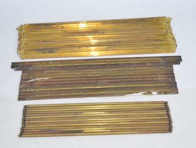 Lot 671 - Three sets of brass stair rods