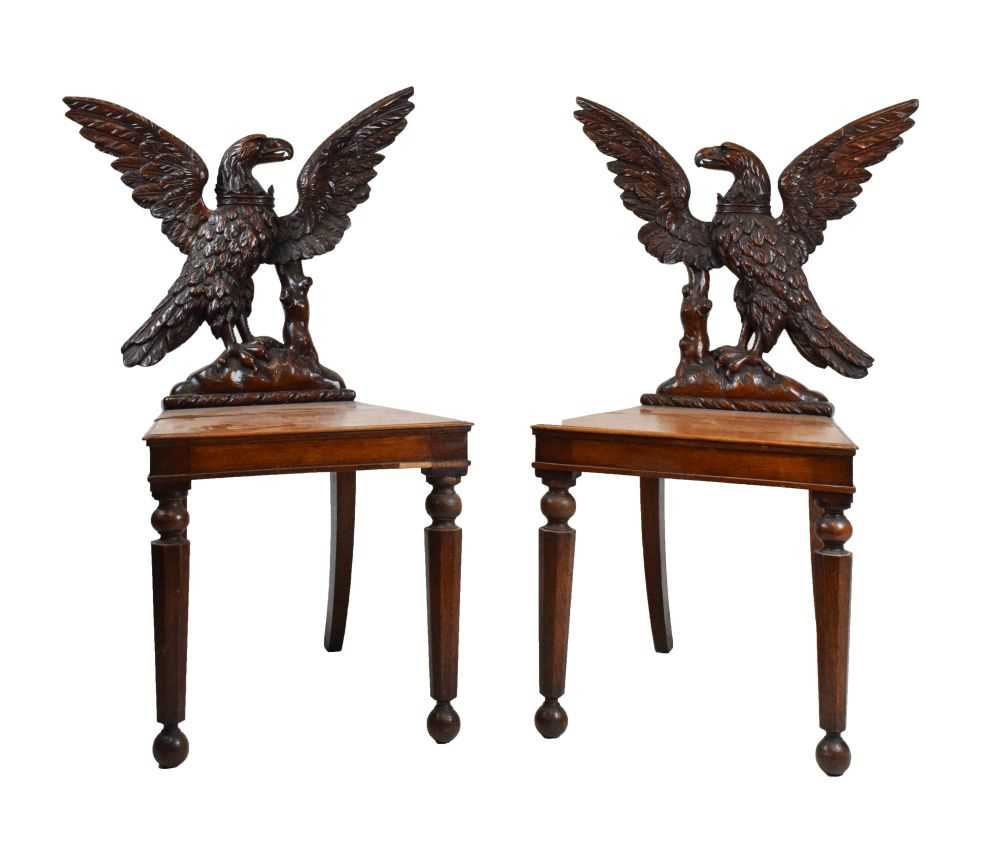 Lot 721 - Pair of Victorian carved oak armorial hall chairs