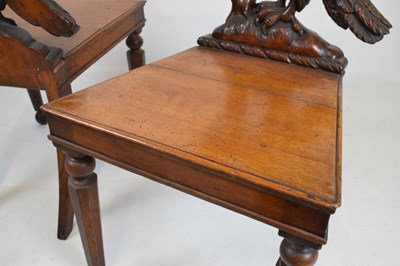 Lot 721 - Pair of Victorian carved oak armorial hall chairs