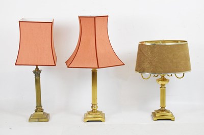 Lot 479 - Three brass column table lamps
