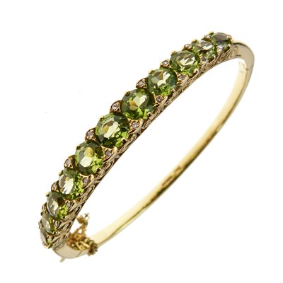 Lot 13 - Edwardian style 14ct gold peridot and diamond hinged bangle