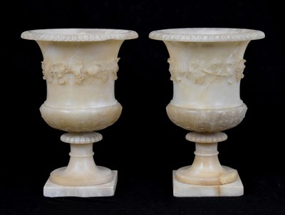 Lot 598 - Pair of alabaster campana shaped pedestal urns