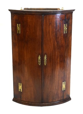 Lot 564 - George III mahogany bowfront hanging corner cupboard