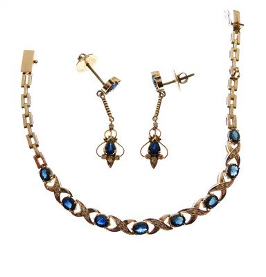Lot 79 - Unmarked yellow metal bracelet  set with eight oval cut sapphires