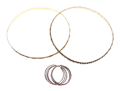 Lot 84 - Two yellow metal bangles, stamped '9K'