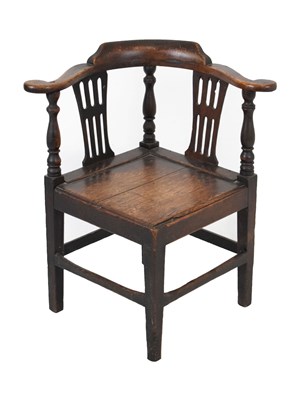 Lot 703 - George III oak 'smoker's bow' corner chair having pierced splat and hard seat