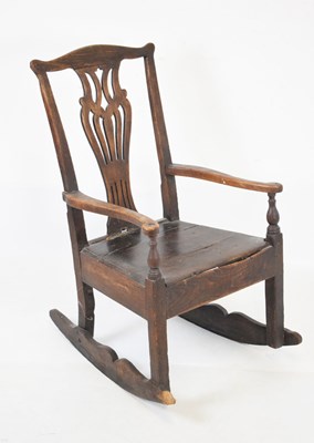 Lot 694 - George III oak rocking armchair