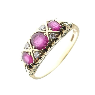 Lot 19 - 18ct gold, ruby, and diamond seven-stone ring