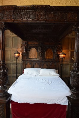 Lot 63 - Impressive carved oak and marquetry-inlaid tester bed