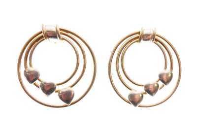 Lot 29 - Pair of bi-colour hoop earrings with heart motifs