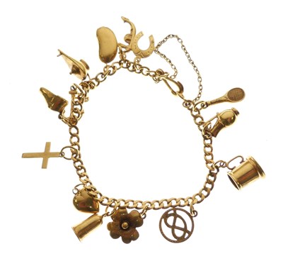 Lot 45 - Yellow metal bracelet with various charms attached