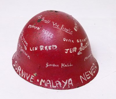 Lot 197 - Malaya Campaign - red painted metal helmet