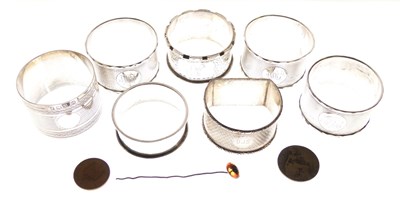Lot 91 - Set of three late Victorian silver napkin rings, plus four singles