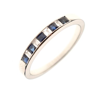 Lot 35 - 9ct white gold half hoop eternity ring, channel set square cut sapphires and baguette cut diamonds