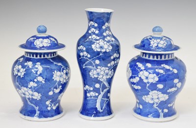 Lot 480 - Chinese blue and white porcelain garniture of three prunus decorated vases