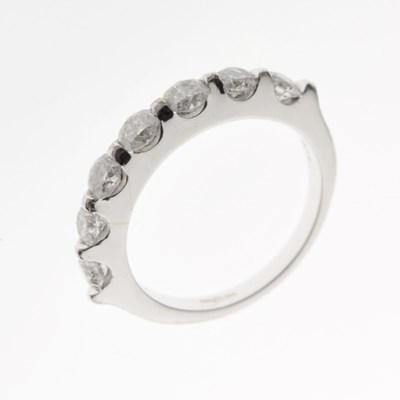 Lot 21 - 18ct white gold half hoop ring set seven diamonds
