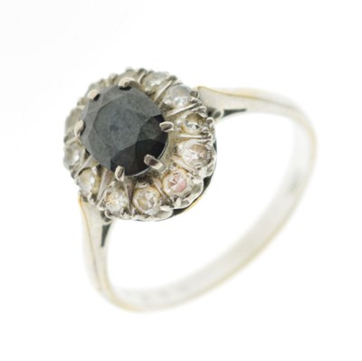Lot 25 - 18ct white metal, sapphire and diamond cluster ring