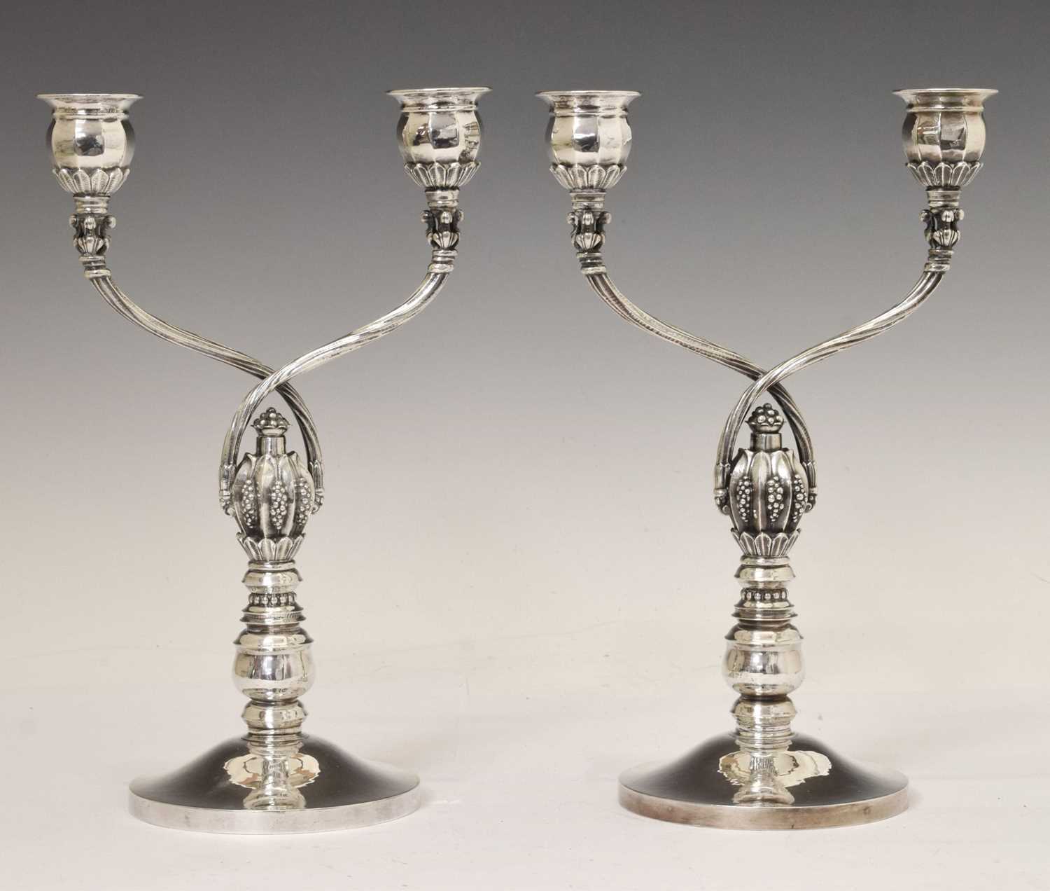Lot 130 - Pair of Georg Jensen sterling silver two-branch candelabra