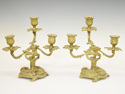 Lot 306 - Pair of gilt metal rococo style three-branch candelabra