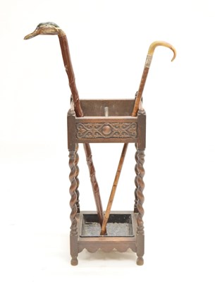 Lot 640 - 1920s oak stick stand and two walking sticks
