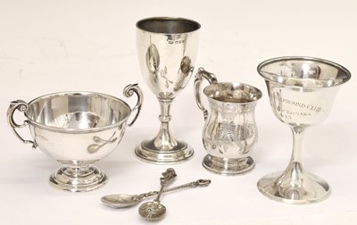 Lot 212 - Three silver trophy cups, a Victorian silver christening mug, and two white-metal spoons