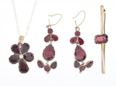 Lot 43 - Foil-backed garnet and seed pearl pendant in the form of a flower head