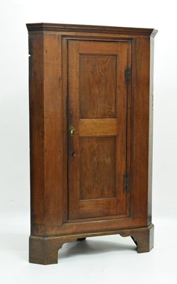 Lot 652 - George III floor standing oak corner cupboard
