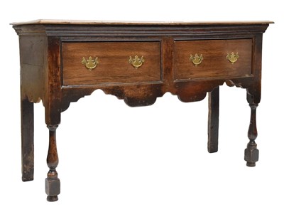 Lot 695 - George III oak low dresser base of narrow proportions