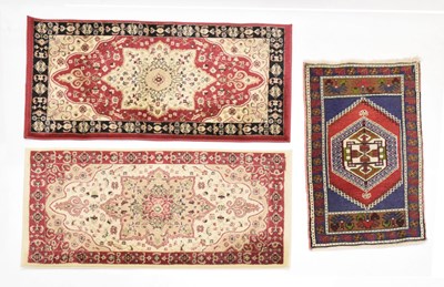 Lot 623 - Three small machine made rugs