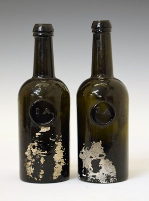 Lot 42 - Two early 19th century dark green glass Utility bottles
