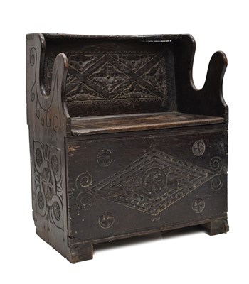Lot 75 - Child’s primitive carved oak box settle