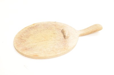 Lot 235 - Workshop of Robert 'Mouseman' Thompson - English oak oval cheese board
