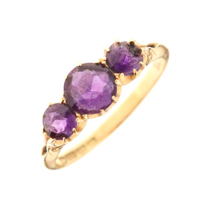 Lot 22 - Edwardian 18ct gold ring set three amethyst-coloured stones