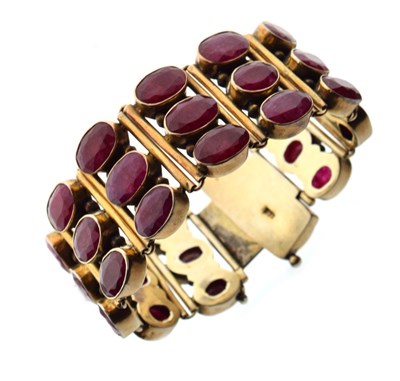 Lot 40 - Silver-gilt bracelet of three rows of oval faceted rubies