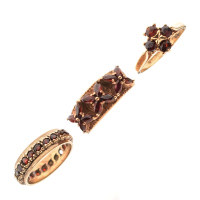 Lot 30 - Two 9ct gold dress rings each set garnet-coloured stones