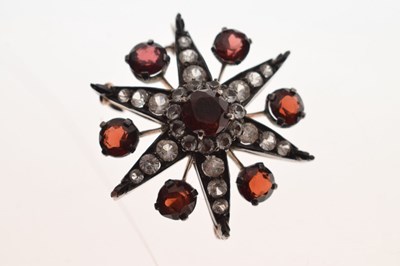 Lot 28 - Victorian garnet and white stone pendant brooch, starburst